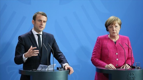 «ميركل وماكرون» يدينان